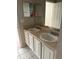 Bathroom features a double vanity with mirrors and white cabinets at 5681 Bentgrass Dr # 13-201, Sarasota, FL 34235
