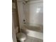 Bright bathroom featuring a tub-shower combination with white tile surround and a standard toilet at 5681 Bentgrass Dr # 13-201, Sarasota, FL 34235