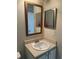 Bathroom featuring mirrors and a white sink and vanity at 5681 Bentgrass Dr # 13-201, Sarasota, FL 34235