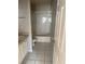 Standard bathroom showcasing a tiled floor and a tub-shower with white tile surround at 5681 Bentgrass Dr # 13-201, Sarasota, FL 34235