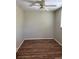 Neutral bedroom with wood-look floors, a ceiling fan, and a window with blinds for natural light at 5681 Bentgrass Dr # 13-201, Sarasota, FL 34235