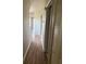 Hallway featuring wood floors and access to a closet at 5681 Bentgrass Dr # 13-201, Sarasota, FL 34235