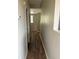 Hallway with wood flooring and a view of the window at 5681 Bentgrass Dr # 13-201, Sarasota, FL 34235