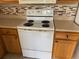 Kitchen featuring white oven and wooden cabinets at 5681 Bentgrass Dr # 13-201, Sarasota, FL 34235