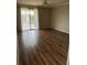 Bright living room featuring wood floors and a sliding door to the balcony at 5681 Bentgrass Dr # 13-201, Sarasota, FL 34235