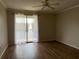 Bright living room featuring wood floors and a sliding door to the balcony at 5681 Bentgrass Dr # 13-201, Sarasota, FL 34235