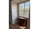Cozy sitting area with natural light, featuring a wood dresser and white blinds at 5681 Bentgrass Dr # 13-201, Sarasota, FL 34235