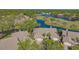An aerial view highlighting the property's location on the water and adjacent to a golf course at 5688 Pipers Waite # 50, Sarasota, FL 34235