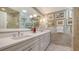 Elegant bathroom featuring double sinks, a large mirror, and stylish wall decor at 5688 Pipers Waite # 50, Sarasota, FL 34235