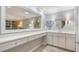 Bright bathroom featuring vanity with a large mirror reflecting into the main bedroom with bookcase and seating at 5688 Pipers Waite # 50, Sarasota, FL 34235