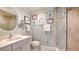 Modern bathroom with decorative artwork on the walls, a glass enclosed shower, and a white vanity at 5688 Pipers Waite # 50, Sarasota, FL 34235
