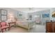 Airy bedroom with a queen bed, ceiling fan, plantation shutters, and natural light at 5688 Pipers Waite # 50, Sarasota, FL 34235