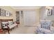Comfortable bedroom with a bench seat, armchair, neutral carpet and ample closet space at 5688 Pipers Waite # 50, Sarasota, FL 34235