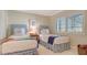 Cozy bedroom with twin beds, a window with shutters, and a colorful throw blanket at 5688 Pipers Waite # 50, Sarasota, FL 34235