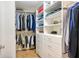 Organized walk-in closet with shelving, drawers, and hanging rods for optimal storage space at 5688 Pipers Waite # 50, Sarasota, FL 34235
