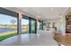 Elegant dining area with a marble table, waterfront views through sliding doors, and access to the living room at 5688 Pipers Waite # 50, Sarasota, FL 34235