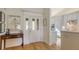Inviting foyer with a decorative front door and hardwood floors, flowing into the kitchen area at 5688 Pipers Waite # 50, Sarasota, FL 34235