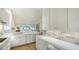 Well-lit kitchen with white cabinets, modern countertops and backsplash, and an open view to the living room at 5688 Pipers Waite # 50, Sarasota, FL 34235
