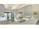 Bright kitchen with white cabinets, stainless steel appliances, and a view to the patio through sliding glass doors at 5688 Pipers Waite # 50, Sarasota, FL 34235