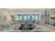 Inviting living room with comfortable seating, built-in bookshelves, and sliding glass doors with a waterfront view at 5688 Pipers Waite # 50, Sarasota, FL 34235