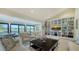 Spacious living room with custom built-ins, comfortable seating, and sliding glass doors overlooking a tranquil view at 5688 Pipers Waite # 50, Sarasota, FL 34235