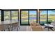 Bright living area featuring sliding glass doors with peaceful waterfront views, elegant furnishings, and lots of light at 5688 Pipers Waite # 50, Sarasota, FL 34235