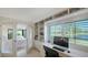Well-lit office space with custom built-ins, providing a functional and organized work area at 5688 Pipers Waite # 50, Sarasota, FL 34235