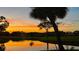 Picturesque sunset reflecting on a tranquil pond, showcasing the property's serene environment at 5688 Pipers Waite # 50, Sarasota, FL 34235