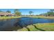 Scenic view of a tranquil pond surrounded by lush greenery, offering a serene and picturesque setting at 5688 Pipers Waite # 50, Sarasota, FL 34235