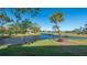 Picturesque waterfront view featuring a calm canal, lush greenery, and nearby homes on a sunny day at 5688 Pipers Waite # 50, Sarasota, FL 34235