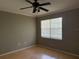 Bright bedroom with wood flooring, ceiling fan, and a large window for natural light at 5691 Bentgrass Dr # 15-102, Sarasota, FL 34235