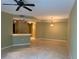Spacious living area boasting tile flooring, a ceiling fan, and a partial view of the kitchen at 5691 Bentgrass Dr # 15-102, Sarasota, FL 34235