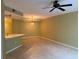 Open living space with tiled floors, a ceiling fan, and a view of the kitchen at 5691 Bentgrass Dr # 15-102, Sarasota, FL 34235