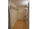 Spacious walk-in closet features wood floors and metal organizers for ample storage at 5691 Bentgrass Dr # 15-102, Sarasota, FL 34235