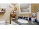 Cozy bathroom featuring granite countertops, a modern sink, and a well-lit mirror at 6342 7Th W Ave # 6342, Bradenton, FL 34209