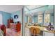 Bedroom with a vanity area, large mirror, a chair and access to the shower at 6342 7Th W Ave # 6342, Bradenton, FL 34209