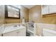 This bathroom features tan walls, a cream countertop, vanity and towel rack at 6342 7Th W Ave # 6342, Bradenton, FL 34209