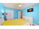 Well-lit bedroom featuring blue walls, hardwood floors, and a comfortable bed at 6342 7Th W Ave # 6342, Bradenton, FL 34209