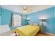 Bright bedroom with turquoise walls, wood floors, and stylish bedside lamps at 6342 7Th W Ave # 6342, Bradenton, FL 34209