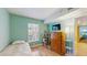 Cozy bedroom features laminate flooring, natural light, a flatscreen tv and light green paint at 6342 7Th W Ave # 6342, Bradenton, FL 34209
