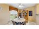 Dining room with a view of the landscaped backyard, a side window, and a view of the kitchen at 6342 7Th W Ave # 6342, Bradenton, FL 34209