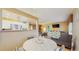 Dining area with a round table, access to the living room and a partial view into the kitchen at 6342 7Th W Ave # 6342, Bradenton, FL 34209