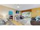 Cozy living room featuring wood floors, reclining sofas, TV, and access to the backyard at 6342 7Th W Ave # 6342, Bradenton, FL 34209