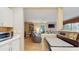 Open-concept living space featuring hardwood floors, a comfortable recliner, and abundant natural light at 6342 7Th W Ave # 6342, Bradenton, FL 34209
