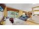 Open-plan living room with a sliding glass door leading to the backyard and a dining area at 6342 7Th W Ave # 6342, Bradenton, FL 34209