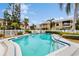 Community pool surrounded by lush landscaping and well-maintained condos on a sunny day at 6342 7Th W Ave # 6342, Bradenton, FL 34209