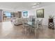 Bright dining room with a glass-top table, floral-patterned chairs, and a view of the water at 6460 Mourning Dove Dr # 204, Bradenton, FL 34210