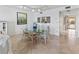 Dining room featuring a glass-top table, floral chairs and views to a tropical balcony at 6460 Mourning Dove Dr # 204, Bradenton, FL 34210