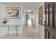Inviting entryway featuring tile flooring, a glass table, and a view into the living area at 6460 Mourning Dove Dr # 204, Bradenton, FL 34210