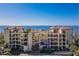 Beautiful condo building with balconies overlooking scenic water views and lush landscaping at 6460 Mourning Dove Dr # 204, Bradenton, FL 34210